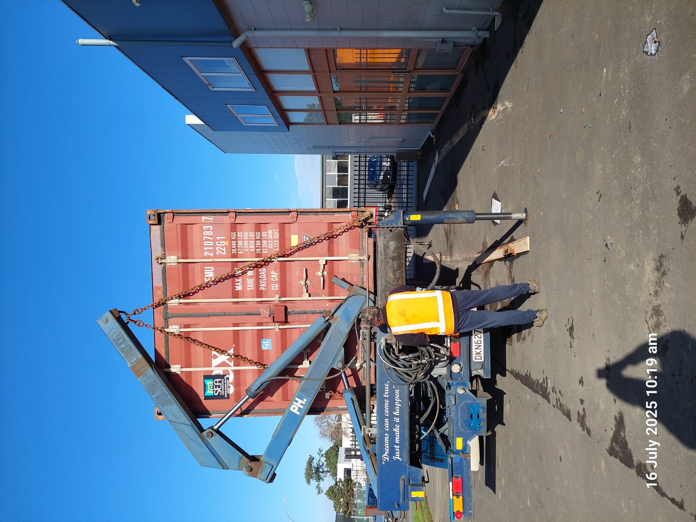 Shipping container being loaded onto a crane truck in Auckland — July 2025, contains two complete Anyplace US-ready units now held in Memphis