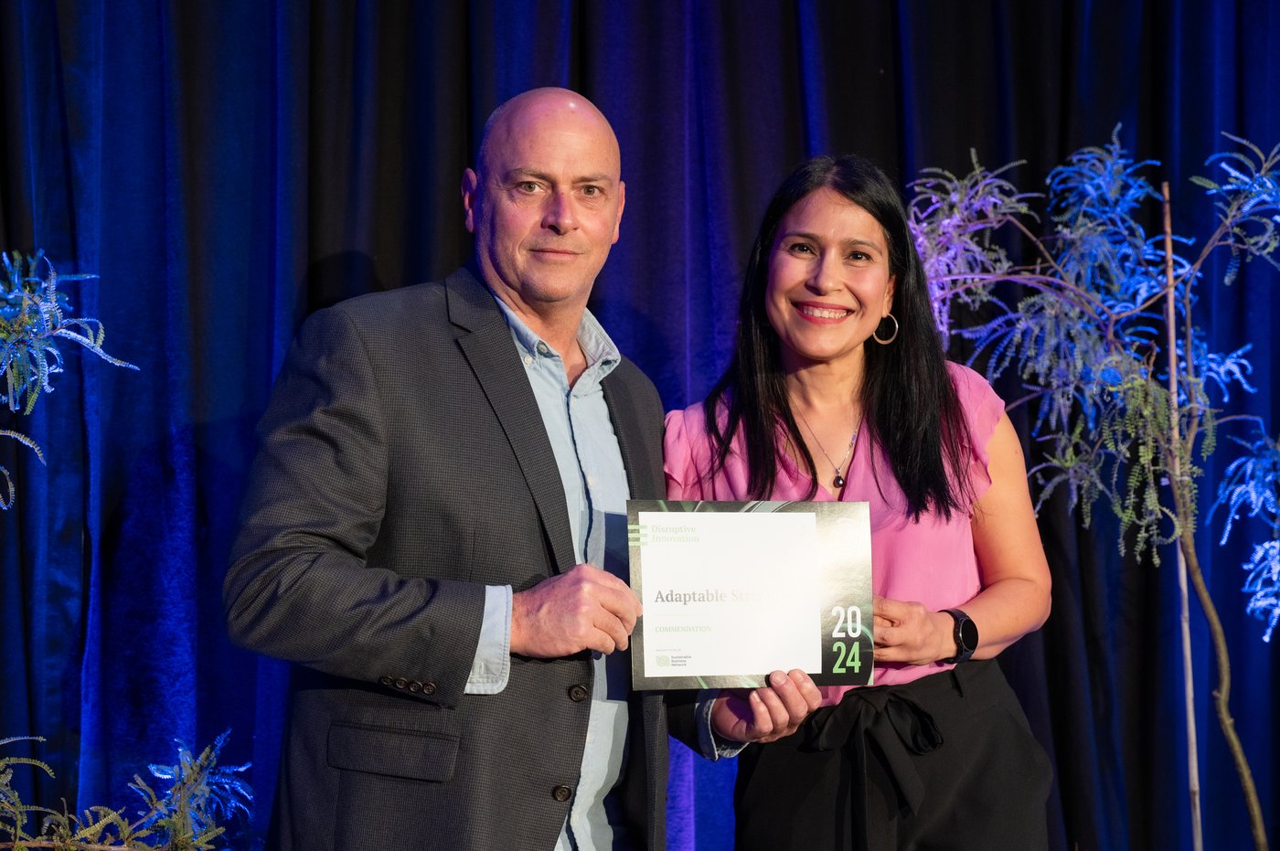 Murphy O'Neal receiving the Sustainable Business Network Next 95 Disruptive Innovation Commendation 2024 on stage